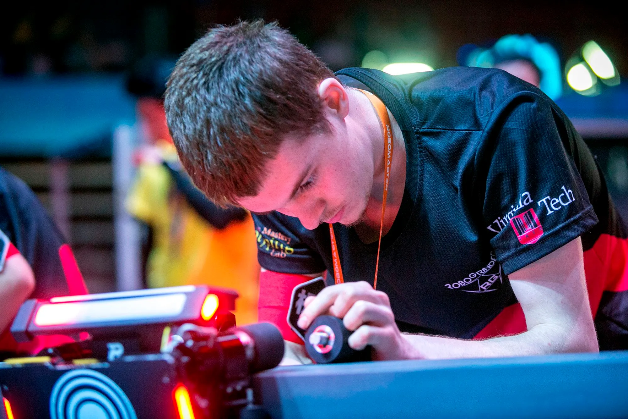 RoboGrinder member fine-tuning a competition robot