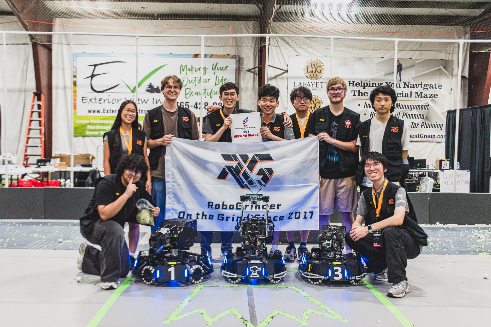 RoboGrinder students and robots at a robotics competition